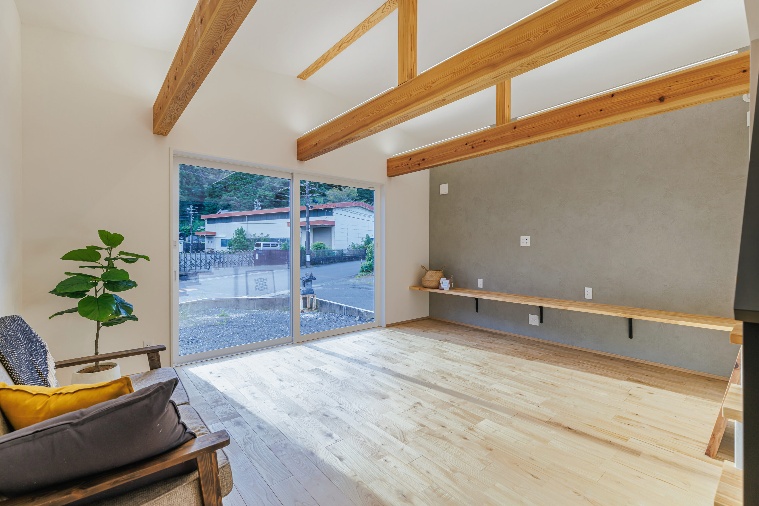 モスグリーンの外壁と木が調和する、静かな佇まいの家の写真16