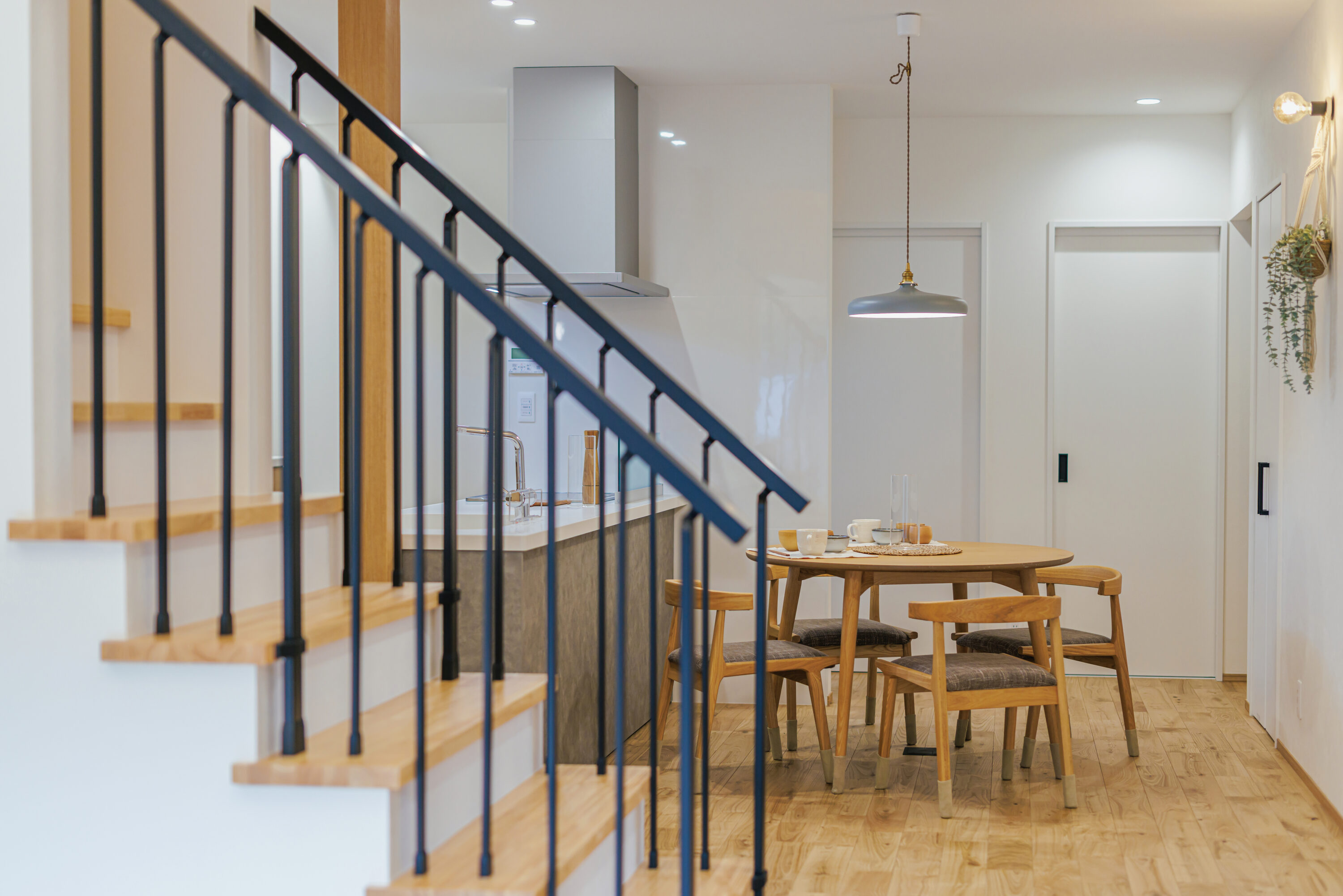 モスグリーンの外壁と木が調和する、静かな佇まいの家の写真5